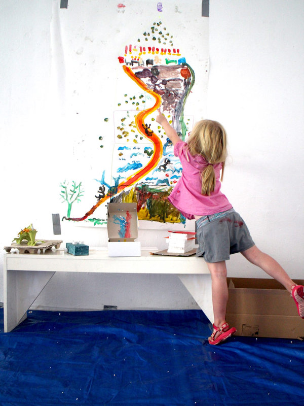 a girl playing with her painting at the final exhibition